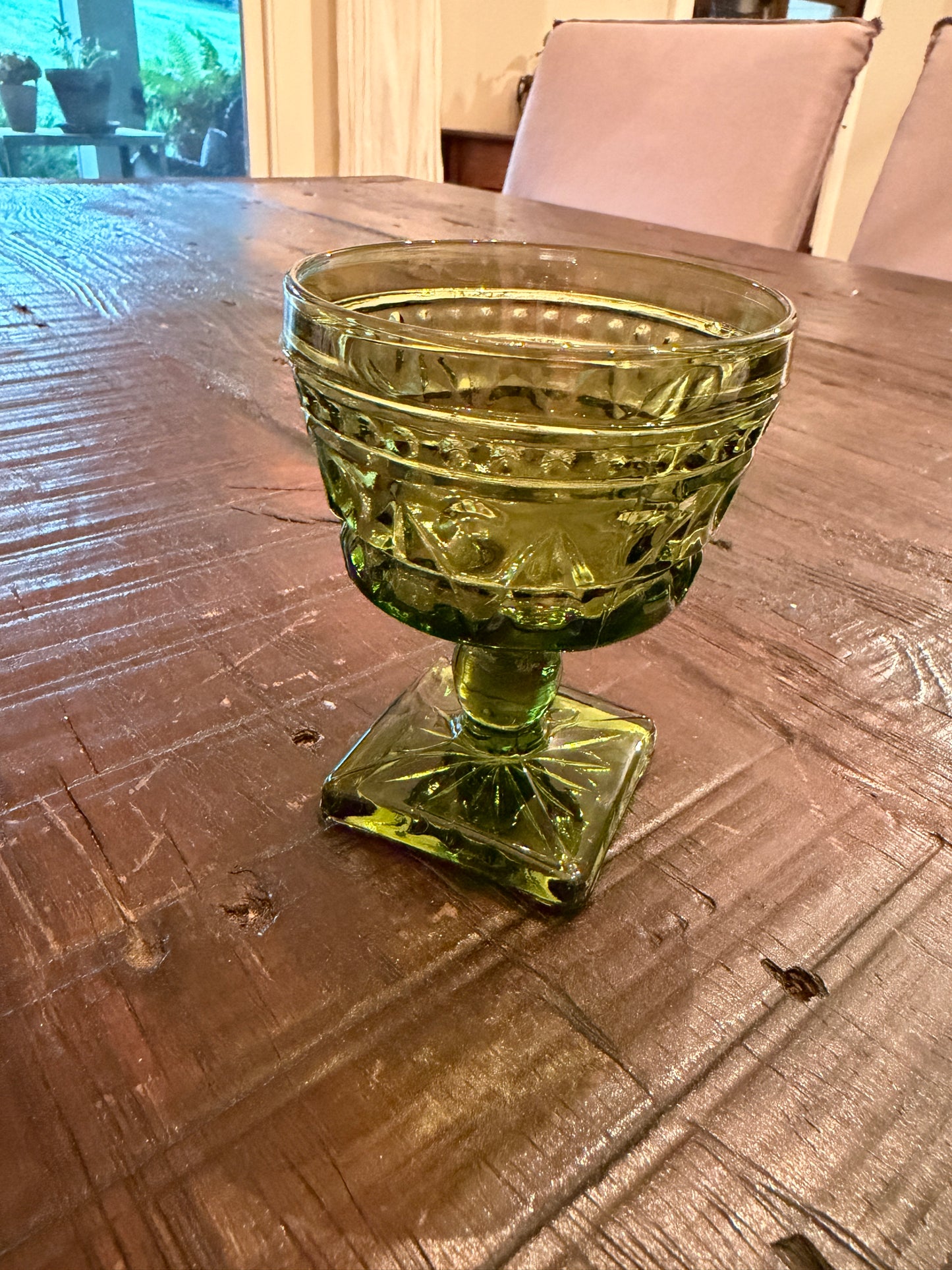 A mid-century  green pressed glass goblet by Indiana Glass.