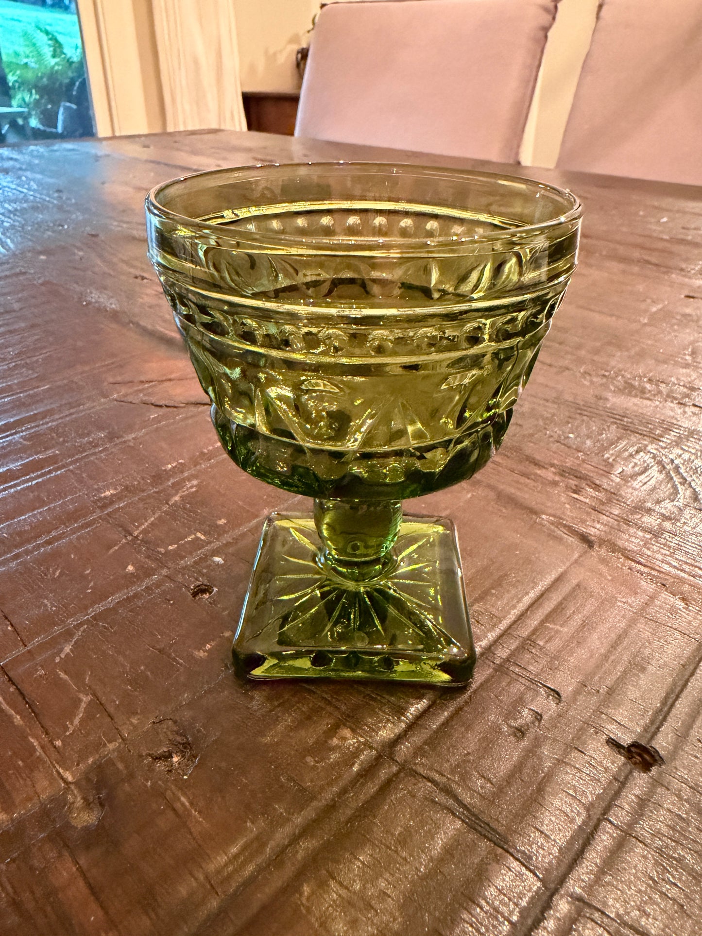 A mid-century  green pressed glass goblet by Indiana Glass.